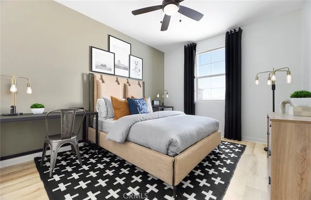 a bedroom with a large bed and a chandelier