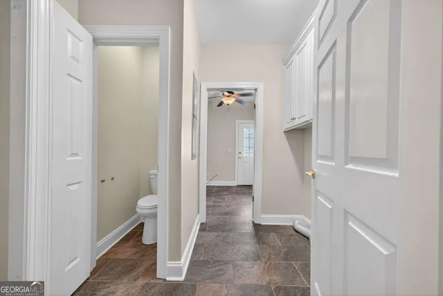 a bathroom with a granite countertop mirror and a toilet