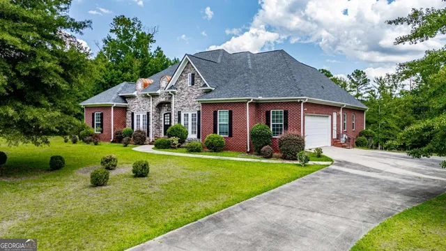 a front view of house with yard and green space