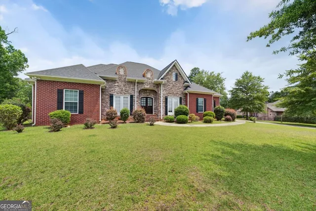 a front view of house with yard and green space