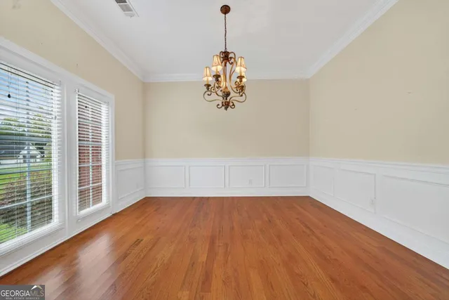 a view of a room with wooden floor chandeliers