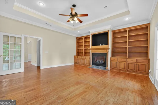 a view of an empty room with a fireplace and a window