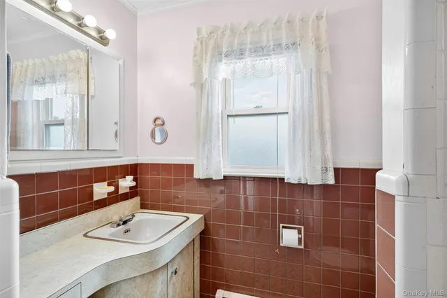 a bathroom with a sink vanity and a mirror