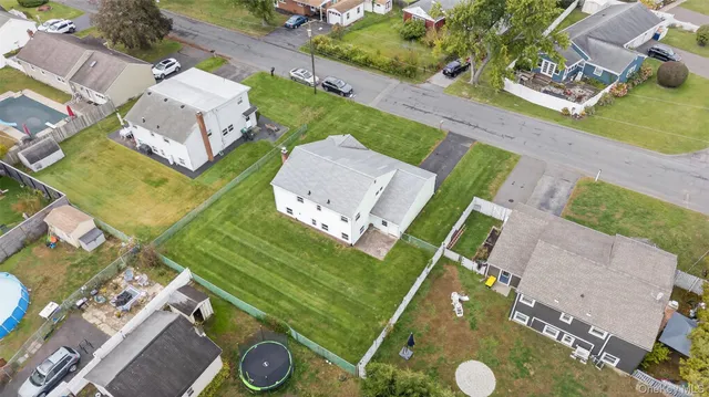 an aerial view of a house with yard
