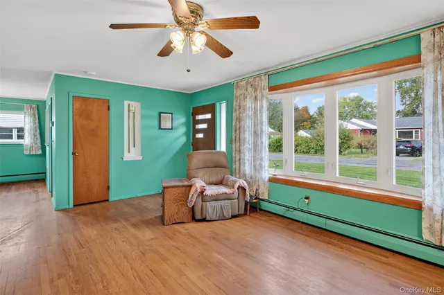 a bedroom with furniture and a large window
