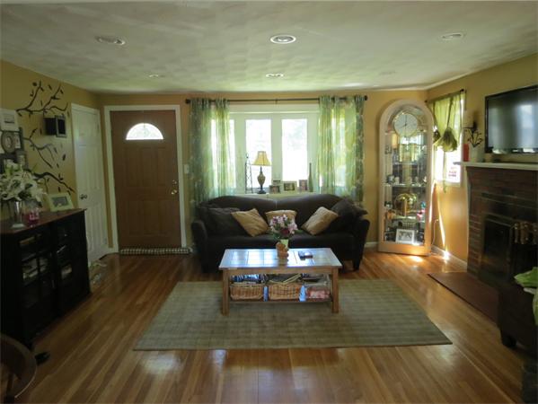 107 Lexington Road Billerica, MA 01821 - Photo 3 of 11 a living room with furniture and a fireplace