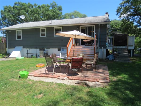 107 Lexington Road Billerica, MA 01821 - Photo 9 of 11 a view of backyard with table and chairs under an umbrella