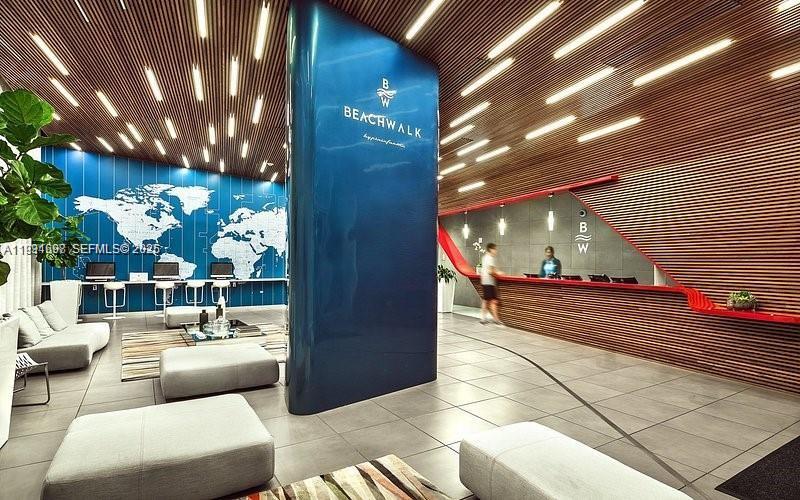 2602 East Hallandale Beach Boulevard, Unit R3010 Hallandale Beach, FL 33009 - Photo 2 of 10 a lobby with furniture and a potted plant