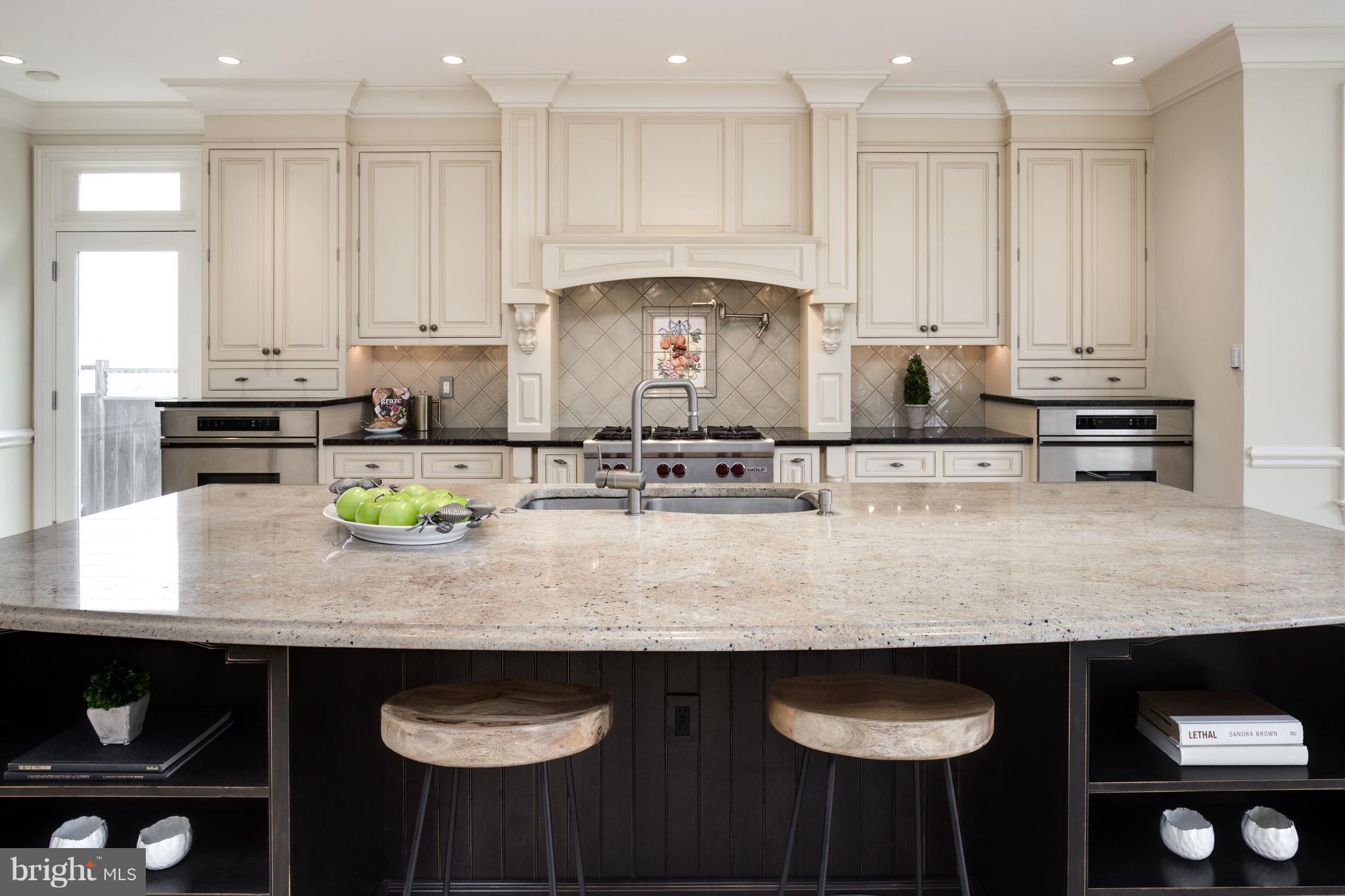 6802 Old Chesterbrook Road McLean, VA 22101 - Photo 11 of 30 a kitchen with stainless steel appliances granite countertop a sink a stove white cabinets and chairs