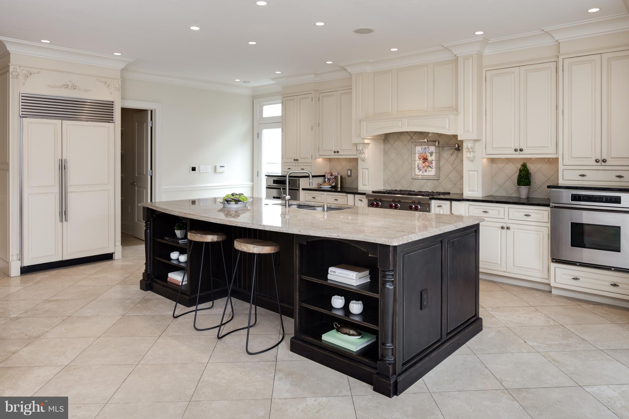6802 Old Chesterbrook Road McLean, VA 22101 - Photo 12 of 30 a kitchen with stainless steel appliances granite countertop a stove a sink and a refrigerator