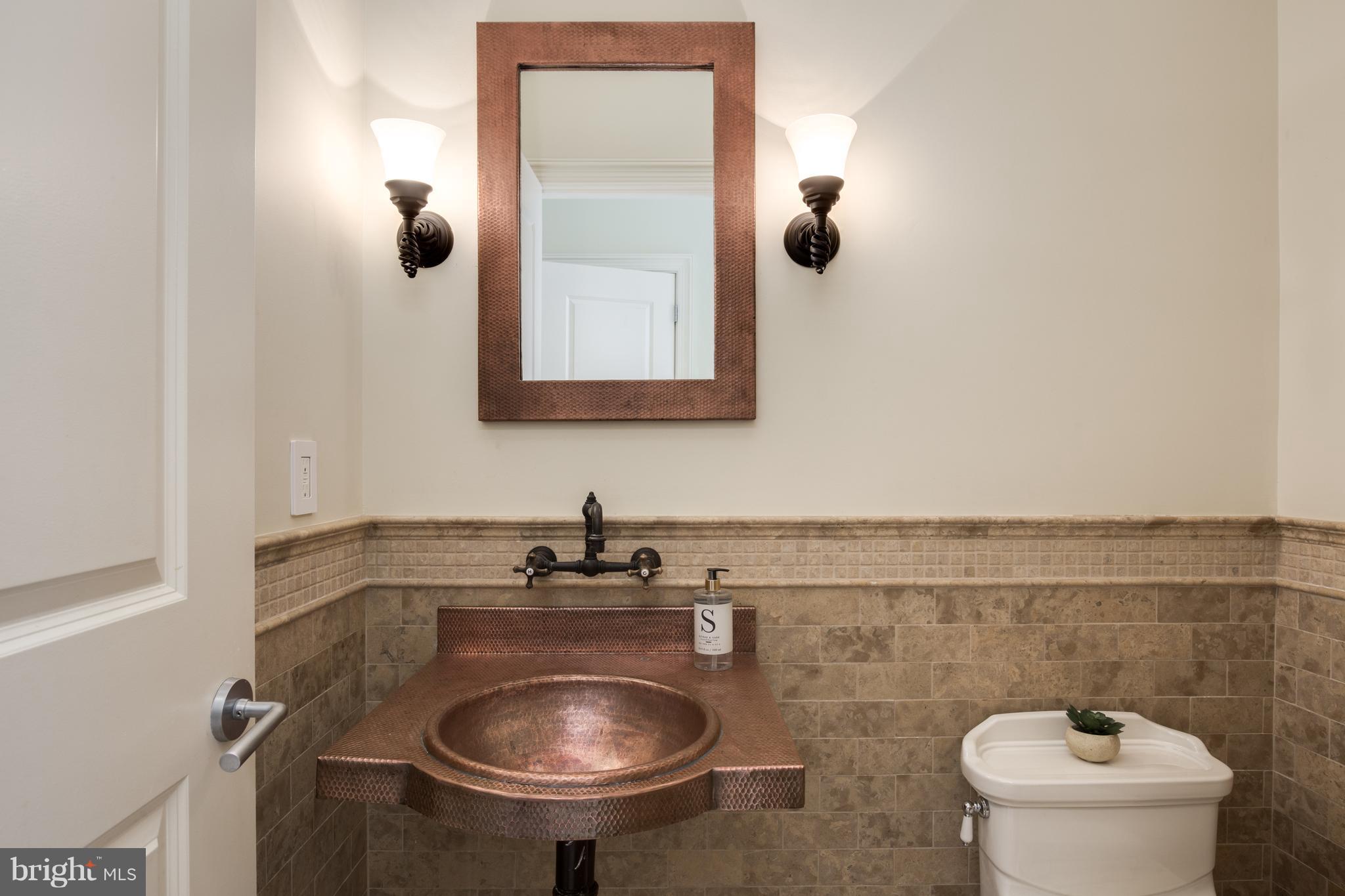 6802 Old Chesterbrook Road McLean, VA 22101 - Photo 17 of 30 a bathroom with a sink a toilet and mirror