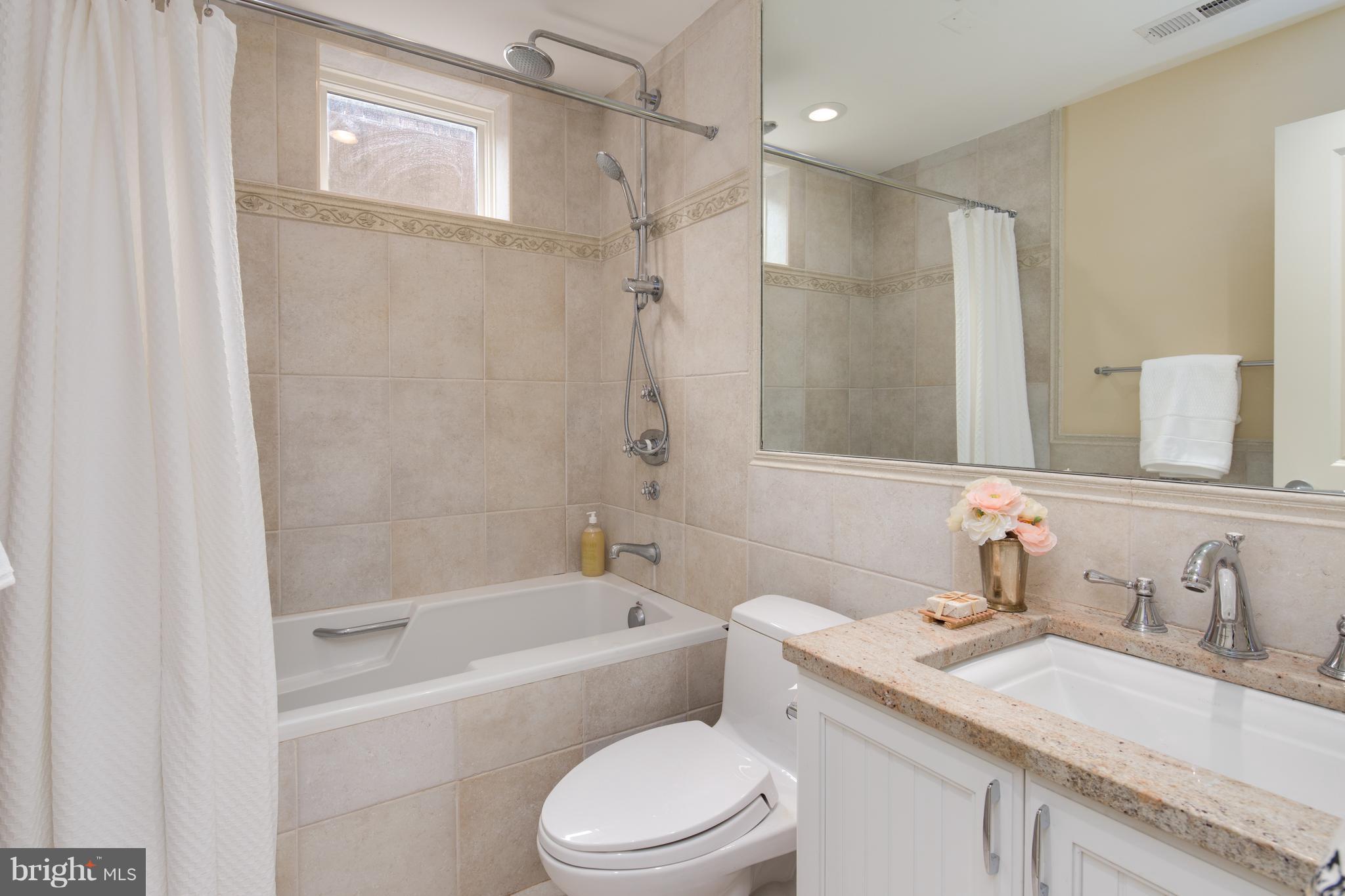 6802 Old Chesterbrook Road McLean, VA 22101 - Photo 28 of 30 a bathroom with a sink toilet vanity and shower