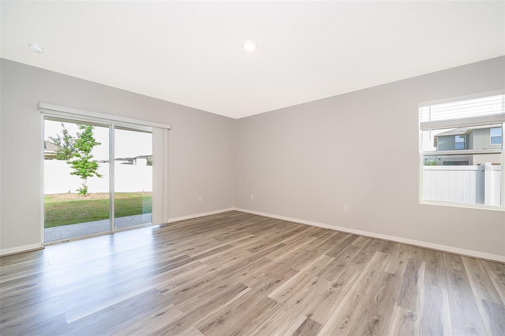 1500 Quinta Road Kissimmee, FL 34744 - Photo 11 of 34 an empty room with wooden floor and windows