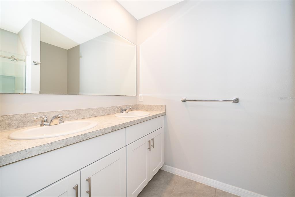 1500 Quinta Road Kissimmee, FL 34744 - Photo 19 of 34 a bathroom with a sink and a mirror