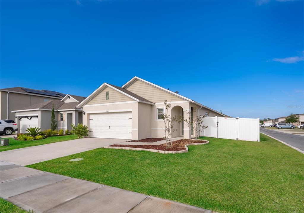 1500 Quinta Road Kissimmee, FL 34744 - Photo 3 of 34 a front view of a house with a yard