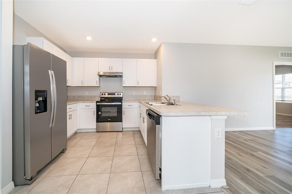 1500 Quinta Road Kissimmee, FL 34744 - Photo 5 of 34 a kitchen with a sink cabinets and stainless steel appliances