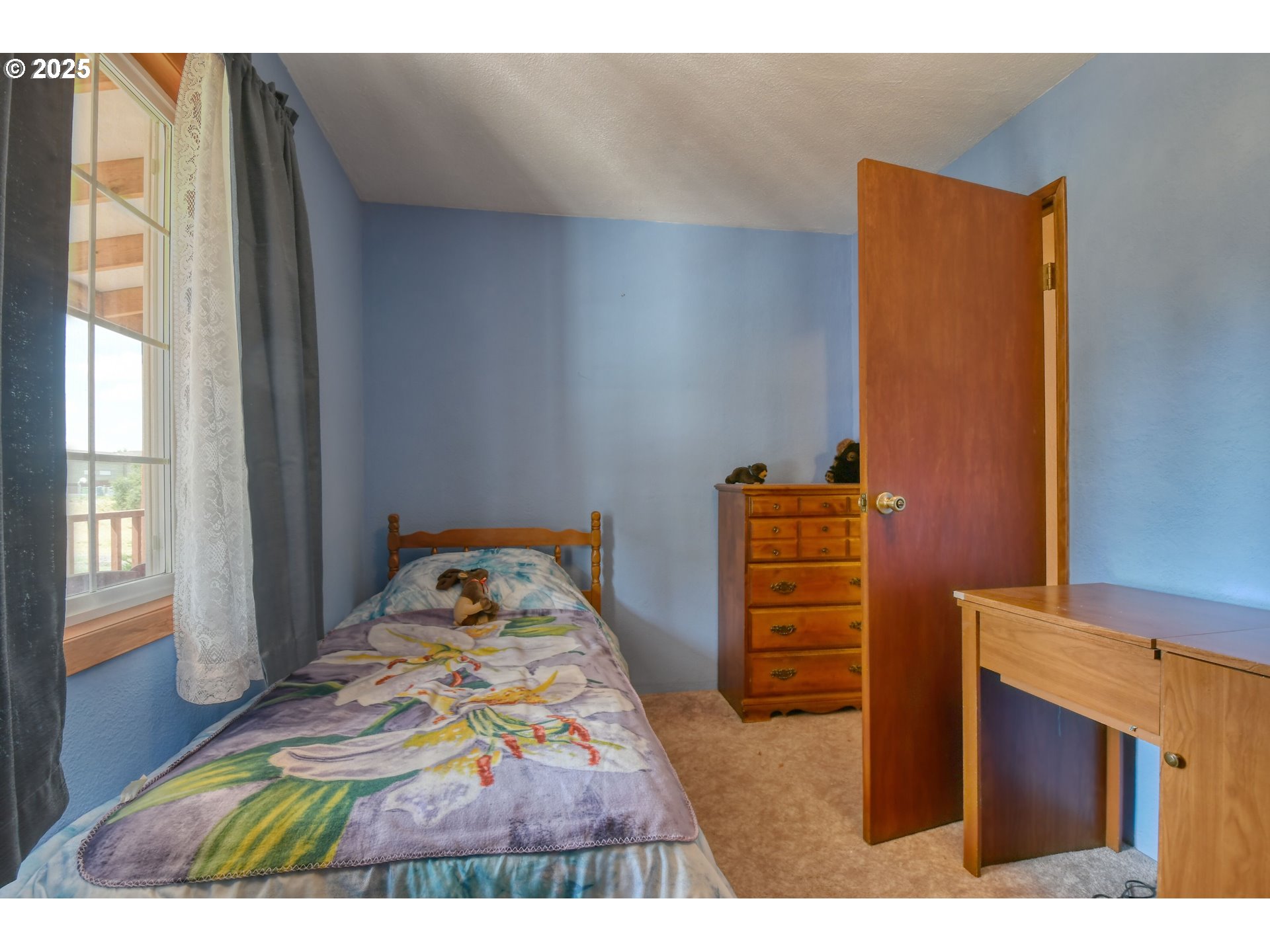 3107 Southwest Ladow Avenue Pendleton, OR 97801 - Photo 22 of 34 a bedroom with a bed and wooden floor
