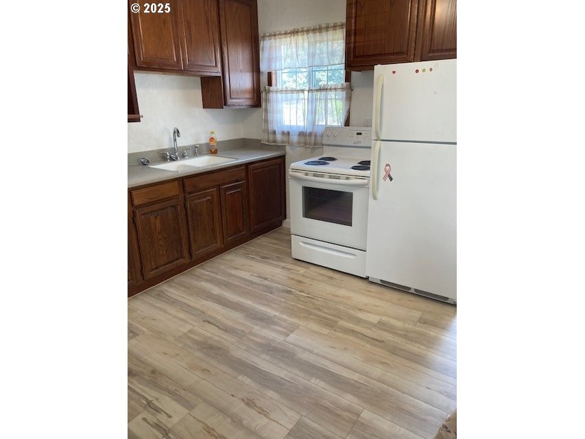 3107 Southwest Ladow Avenue Pendleton, OR 97801 - Photo 7 of 34 a kitchen with stainless steel appliances a sink a stove a microwave and cabinets