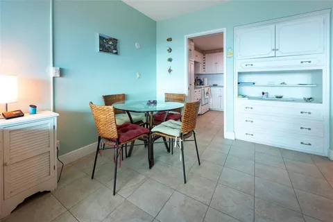 a spacious bedroom with a bed and a chandelier