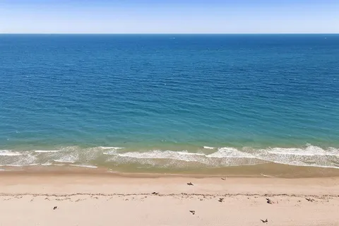 a view of a swimming pool with a yard