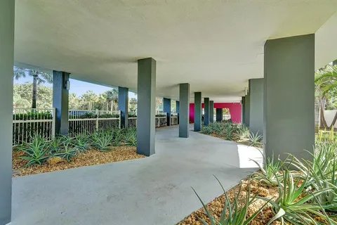 a living room with furniture a potted plant and a large window