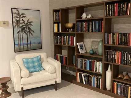 a living room with furniture and a bookshelf