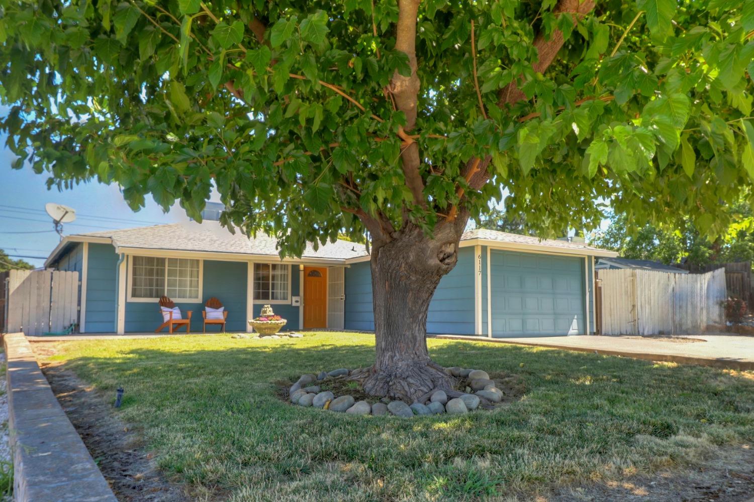a front view of house with yard and green space