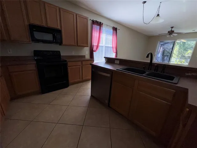 a kitchen with a sink and a stove top oven