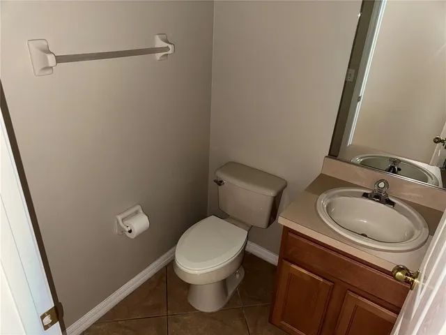 a white toilet sitting next to a bathroom sink