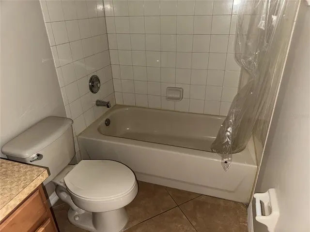 a bathroom with a toilet and a bathtub