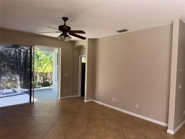 a view of a livingroom with a ceiling fan and window