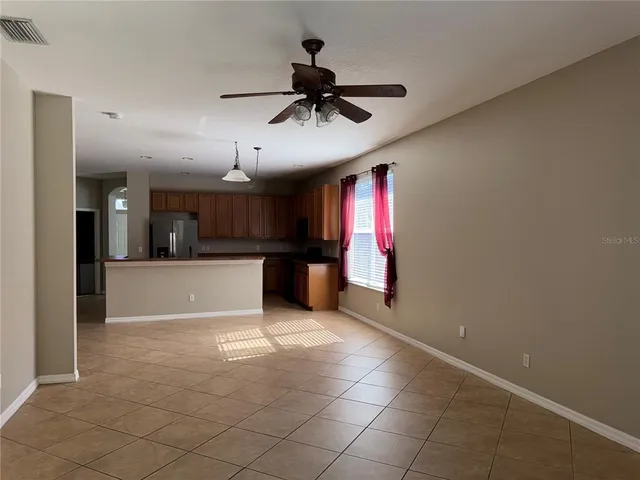 a view of a kitchen with a sink and refrigerator
