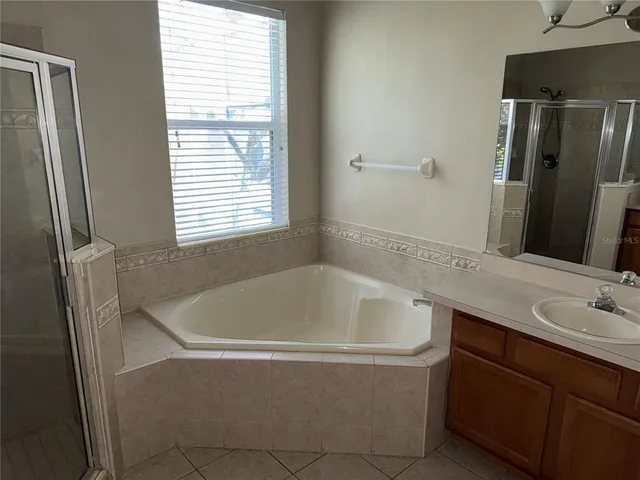 a bath tub sitting next to a bathroom sink