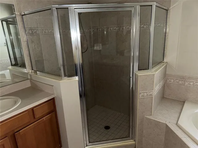 a bathroom with a shower and a sink