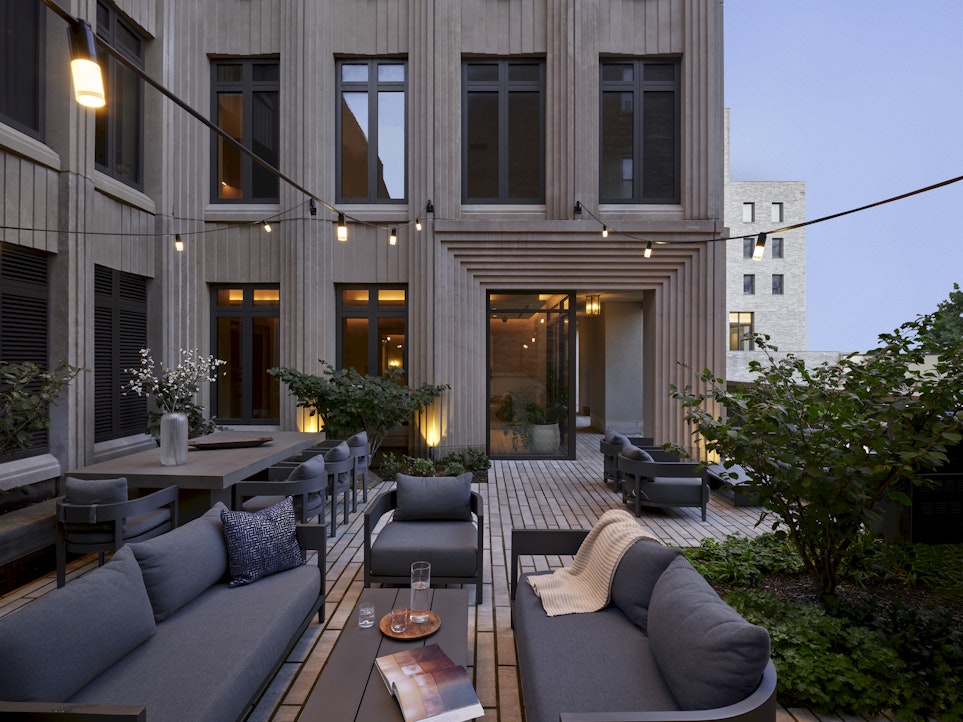 543 West 122nd Street, Unit 16A Manhattan, NY 10027 - Photo 15 of 32 a view of a patio with couches table and chairs potted plants and palm tree