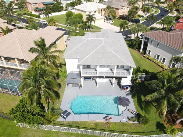 an aerial view of a house with a yard and potted plants