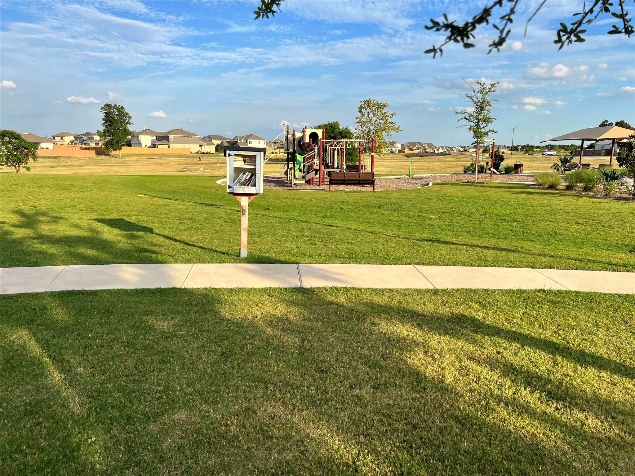 140 Pentro Path Georgetown, TX 78626 - Photo 34 of 37 A vibrant green lawn and inviting playground create a perfect community gathering space.