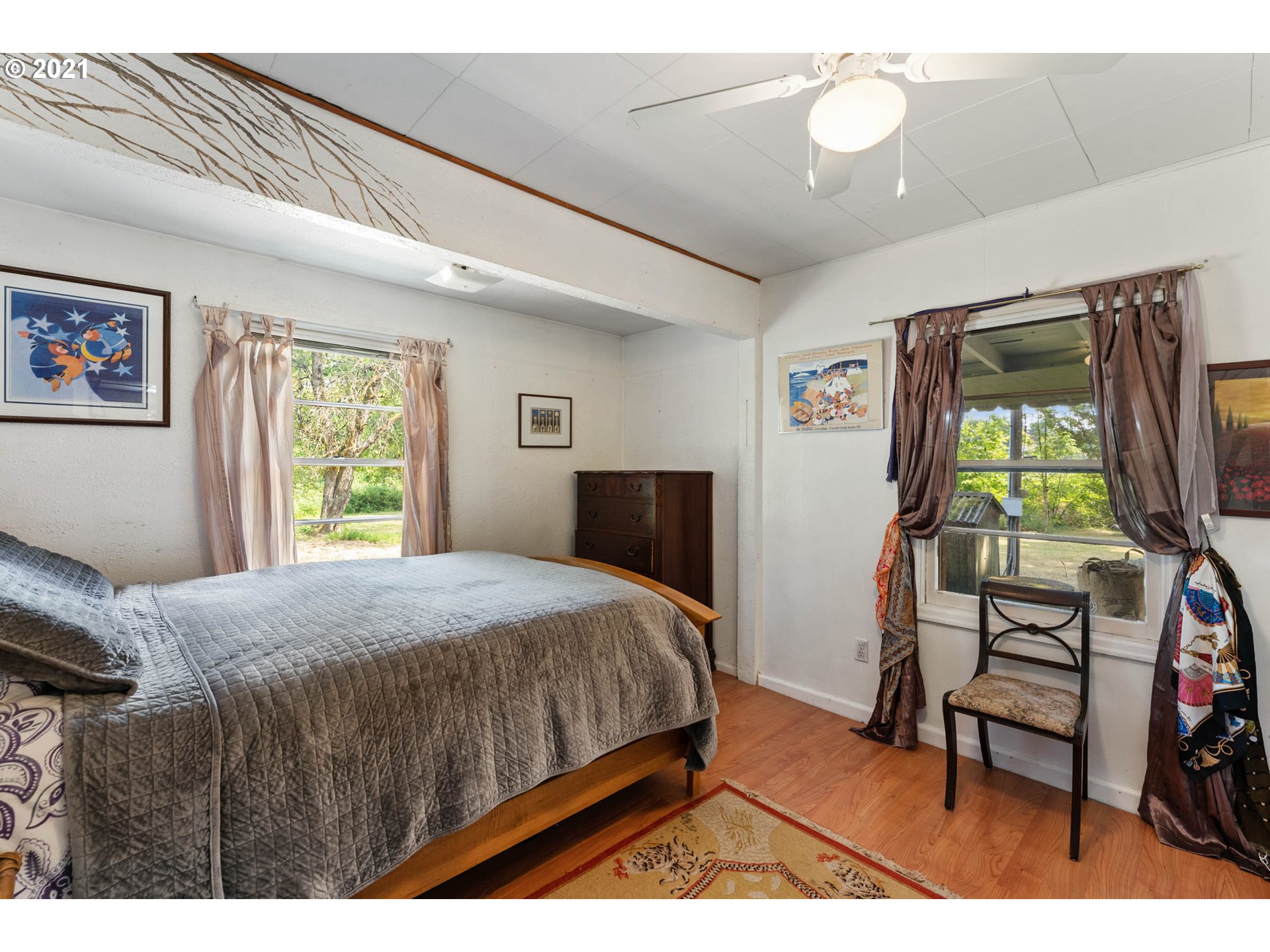 1006 Northeast 194th Street Ridgefield, WA 98642 - Photo 14 of 32 a bedroom with a bed window and a flat tv screen