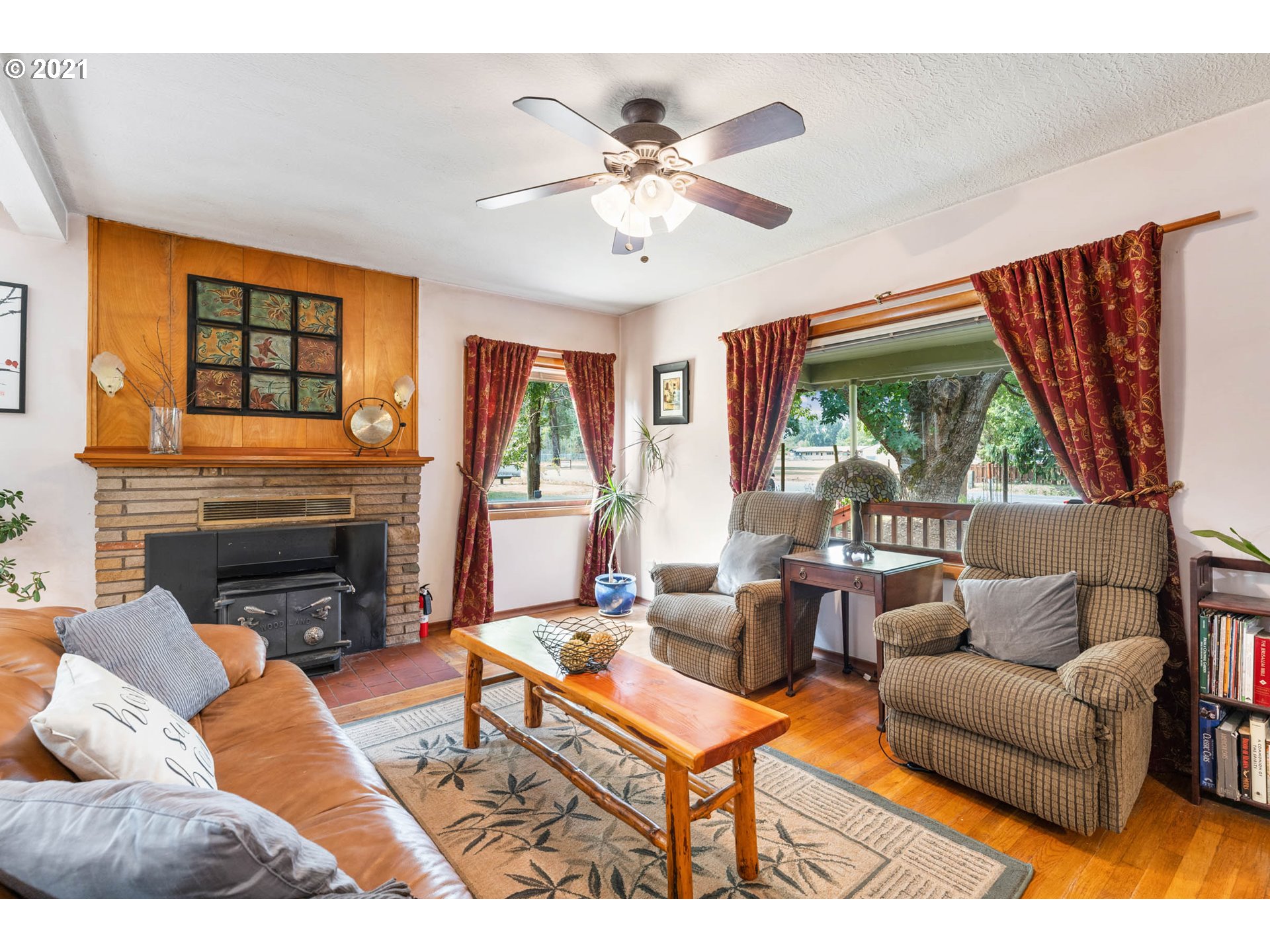 1006 Northeast 194th Street Ridgefield, WA 98642 - Photo 4 of 32 a living room with furniture a fireplace and a large window