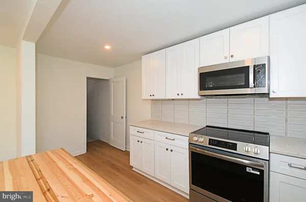 a kitchen with a stove and a microwave