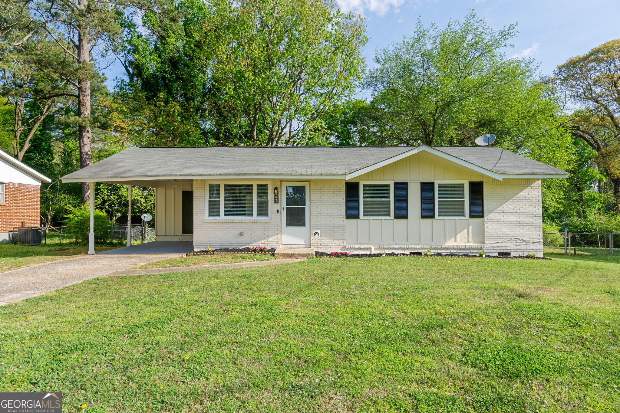 302 Roxbury Drive Riverdale, GA 30274 - Photo 1 of 1 a front view of a house with a garden