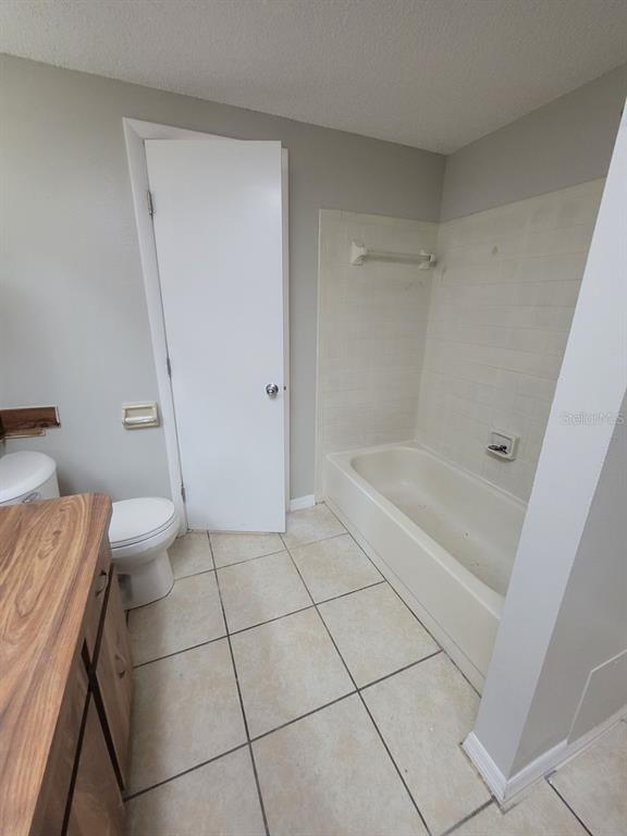 8085 Omaha Circle Spring Hill, FL 34606 - Photo 12 of 18 a bathroom with a granite countertop bathtub and toilet