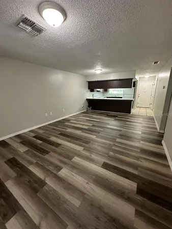 a view of room with wooden floor
