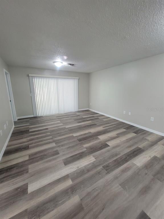 8085 Omaha Circle Spring Hill, FL 34606 - Photo 3 of 18 a view of empty room with wooden floor