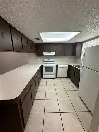 a kitchen with stainless steel appliances a stove a sink and a refrigerator
