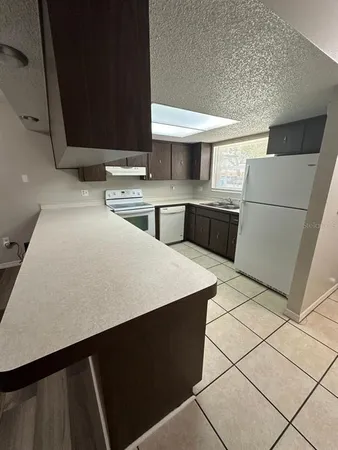 a kitchen with stainless steel appliances a sink and a refrigerator