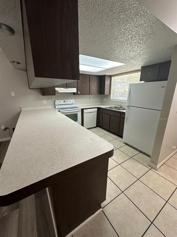 8085 Omaha Circle Spring Hill, FL 34606 - Photo 5 of 18 a kitchen with stainless steel appliances a sink and a refrigerator