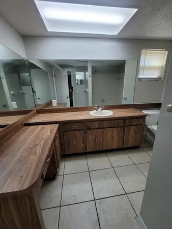 a room with a sink and cabinets
