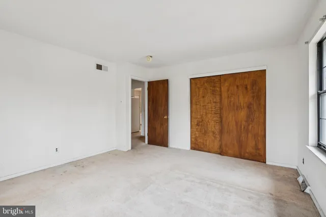 a view of an empty room and closet area