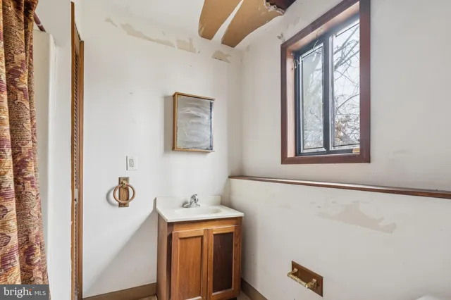 a bathroom with a sink and a window